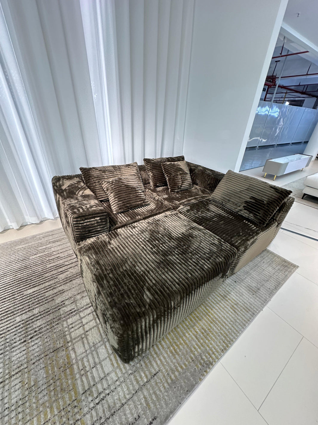 image Brown textured sofa in a modern living room with white walls and floor.