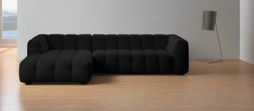 image Black sectional sofa in a minimalistic room with a lamp and window.