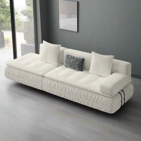 White sofa with cushions on a solid background