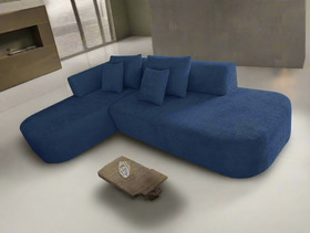 Blue sectional sofa in a modern living room setting with a small table.