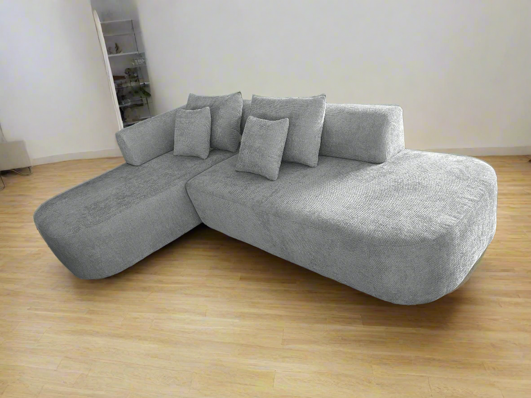 image Gray sectional sofa with cushions on a solid background