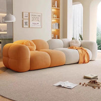 Modern living room with a colorful sofa and decorative items.