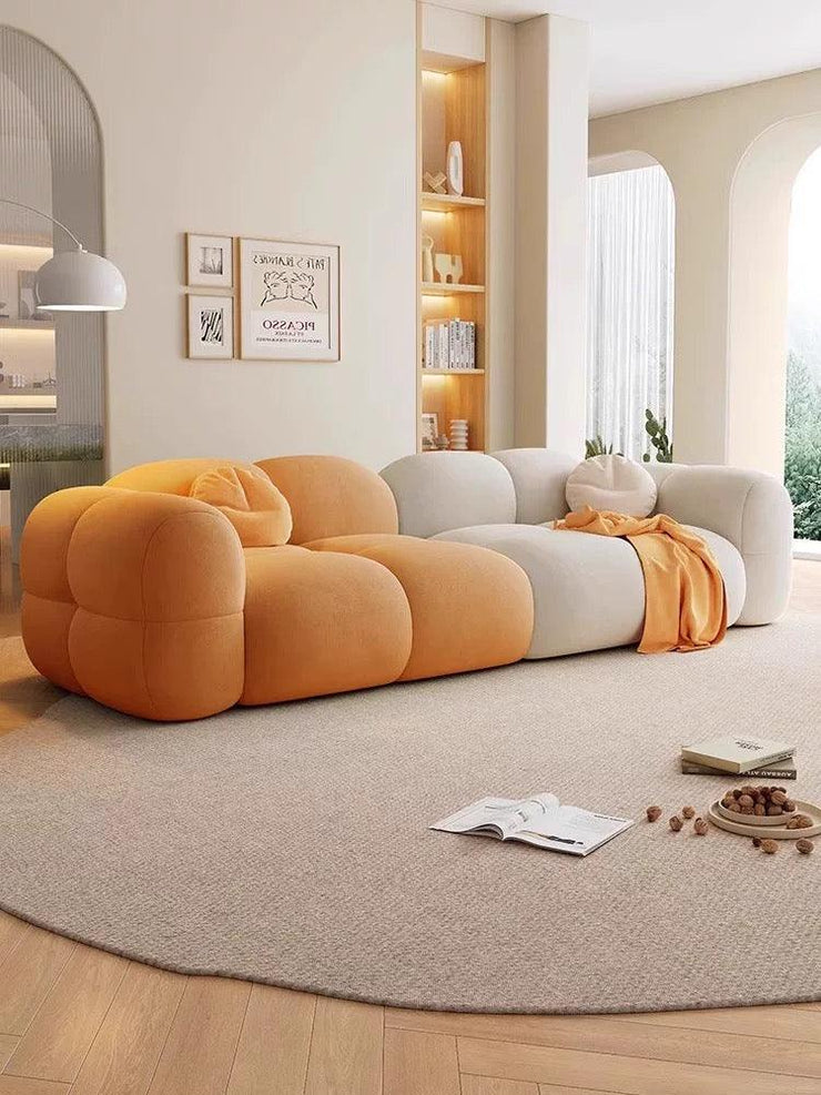 Modern living room with a colorful sofa and decorative items.