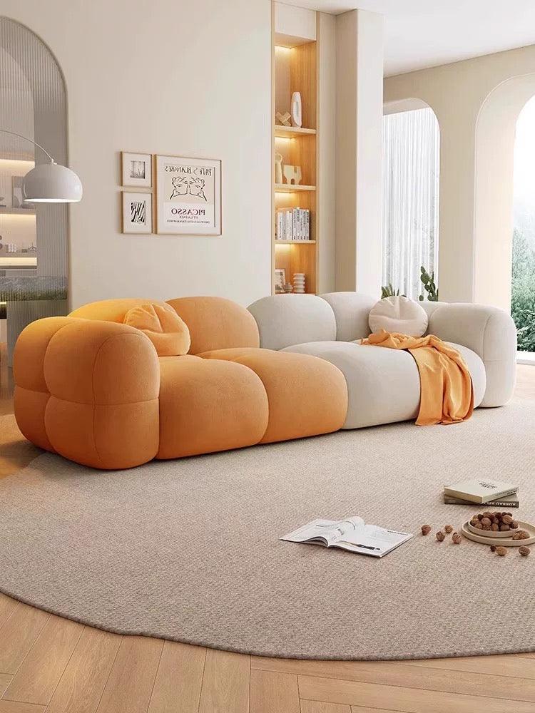 Modern living room with a colorful sofa and decorative items.