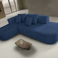 Blue sectional sofa in a modern living room setting with a small table.